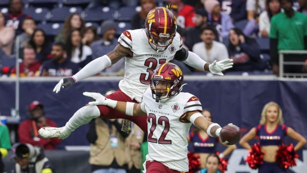 Washington Commanders safeties Darrick Forrest (22) and Kamren Curl (31) celebrate after a turnover against the Houston Texans.